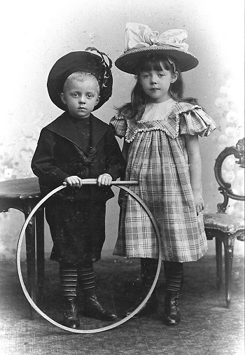 Edwardian Childhood | Siblings with a rolling hoop and a stick, 1900 photo