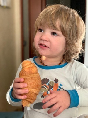 Toddler with croissant