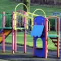 Playground climbing frame with rope bridge