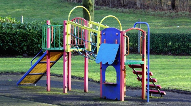 Playground climbing frame with rope bridge