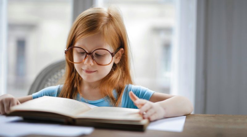 Girl reading a book for her homework | photo by Andrea Piacquadio, pexels